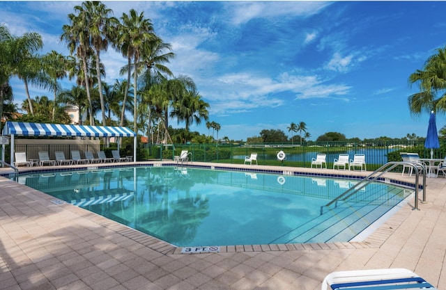 pool featuring a patio area and fence