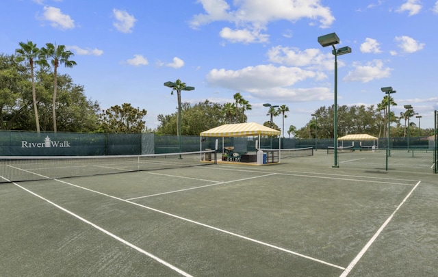 view of tennis court featuring fence