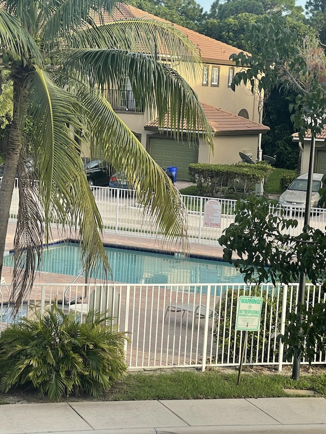 view of swimming pool with fence