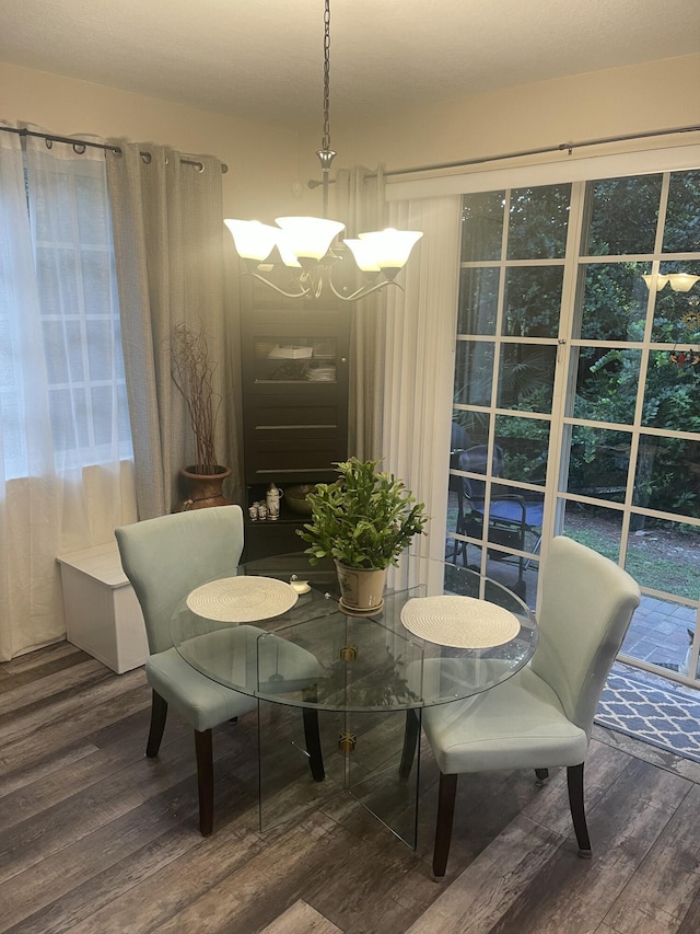 dining space featuring a notable chandelier and wood finished floors