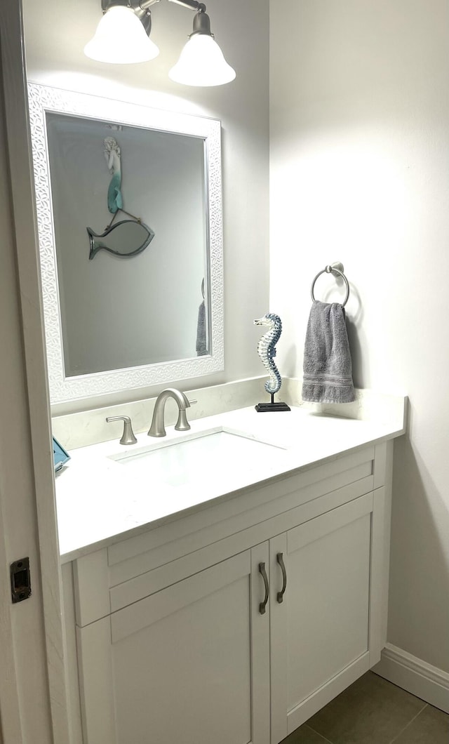 bathroom with tile patterned flooring, vanity, and baseboards