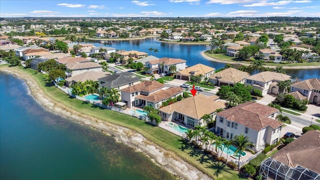 birds eye view of property featuring a residential view and a water view