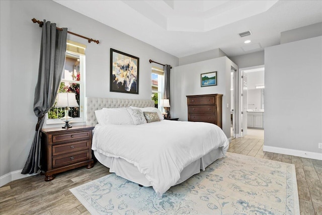 bedroom featuring visible vents, wood finished floors, and baseboards