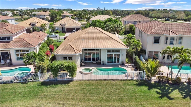 exterior space with a patio area, a residential view, a fenced backyard, and a tiled roof