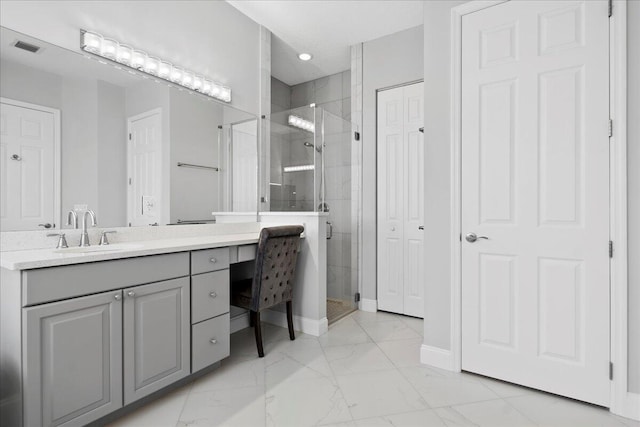 bathroom featuring visible vents, marble finish floor, a stall shower, and vanity