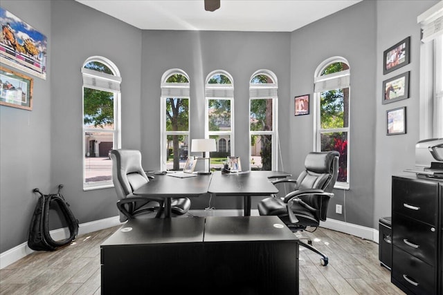 home office featuring light wood-style flooring and baseboards