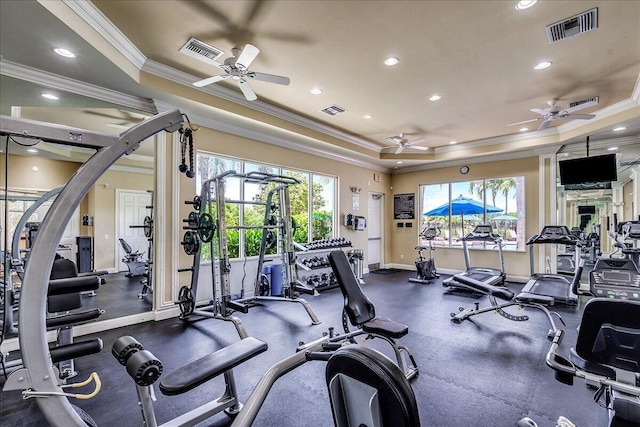 exercise room featuring a tray ceiling, recessed lighting, and visible vents