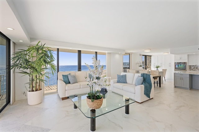 living area featuring recessed lighting, marble finish floor, and expansive windows