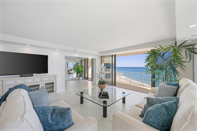 living area with recessed lighting and a water view