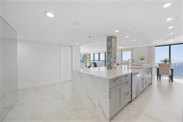 kitchen featuring an island with sink, light stone counters, a sink, recessed lighting, and dishwasher