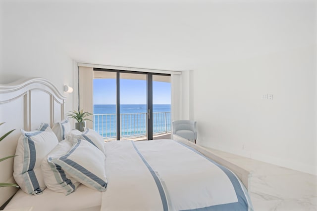 bedroom with a water view, marble finish floor, access to outside, floor to ceiling windows, and baseboards