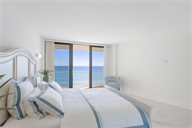 bedroom featuring a water view, marble finish floor, access to outside, a wall of windows, and baseboards