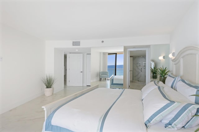 bedroom with visible vents, baseboards, and a water view