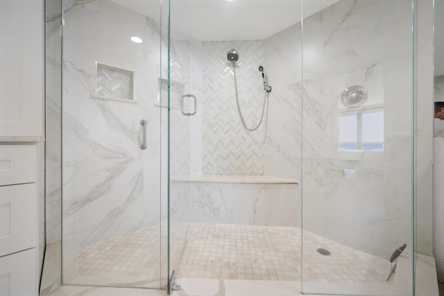 full bath featuring a marble finish shower