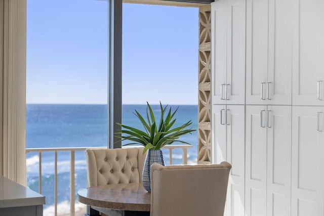 living area featuring a wall of windows and a water view