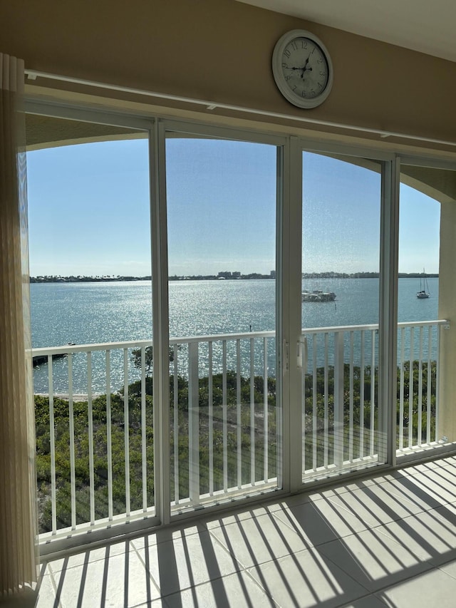 unfurnished sunroom with a water view