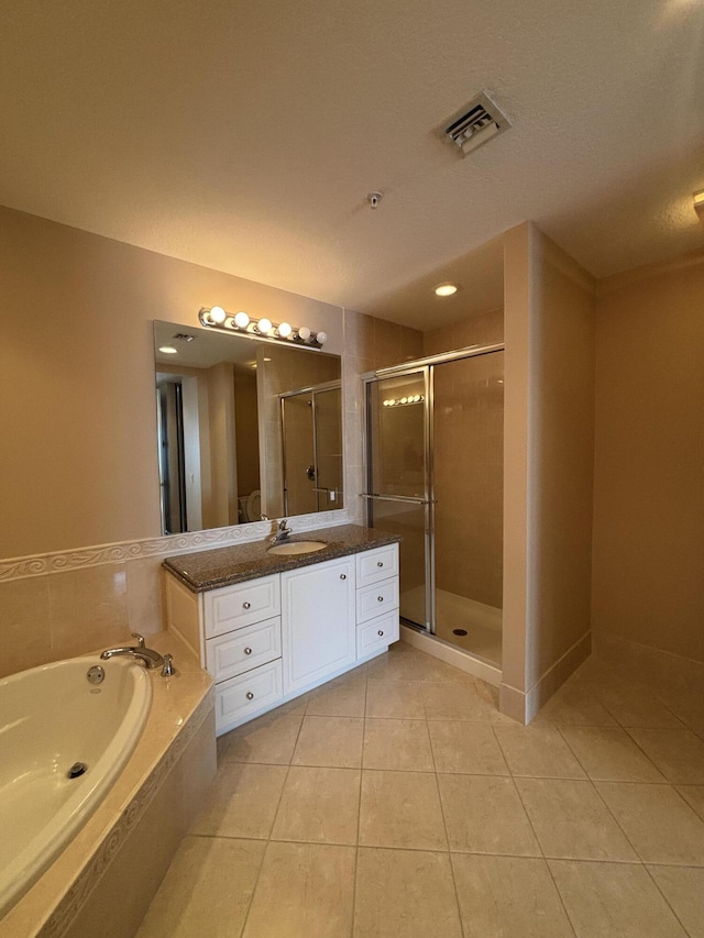 bathroom with tile patterned flooring, vanity, visible vents, and a stall shower