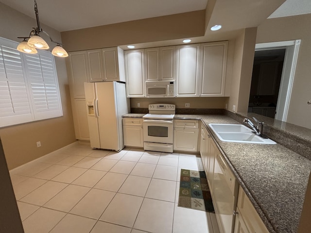 kitchen featuring decorative light fixtures, light tile patterned floors, recessed lighting, white appliances, and a sink