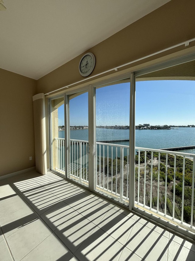 unfurnished sunroom featuring a water view and vaulted ceiling