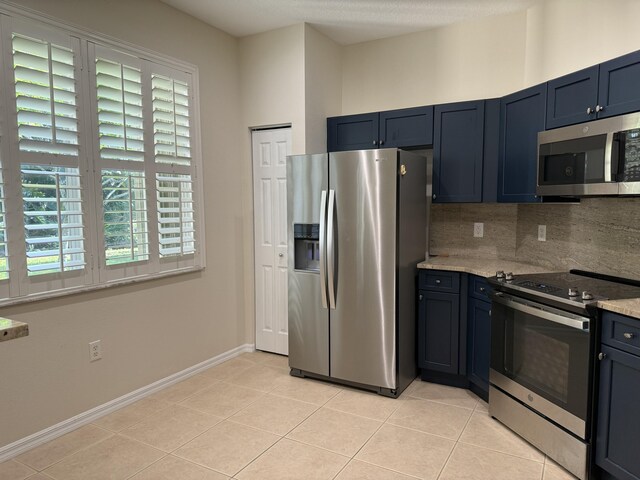 560 SW Indian Key Dr S, Saint Lucie West, FL 34986 - kitchen with appliances with stainless steel finishes, light tile patterned floors, and a healthy amount of sunlight