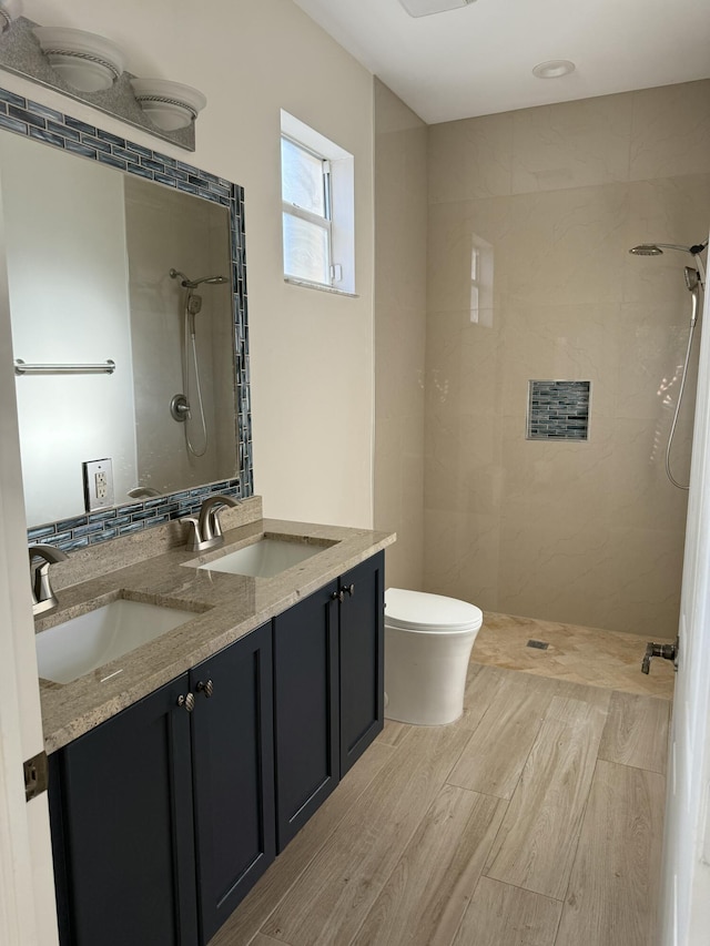 560 SW Indian Key Dr S, Saint Lucie West, FL 34986 - full bathroom with toilet, a sink, tiled shower, and wood finished floors