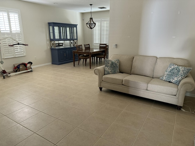 living area featuring tile patterned floors and baseboards