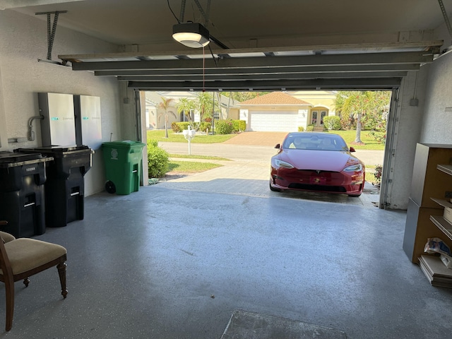 garage featuring a garage door opener and a textured wall