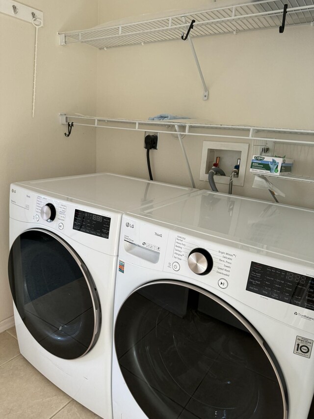 560 SW Indian Key Dr S, Saint Lucie West, FL 34986 - laundry room featuring washing machine and dryer, light tile patterned flooring, and laundry area