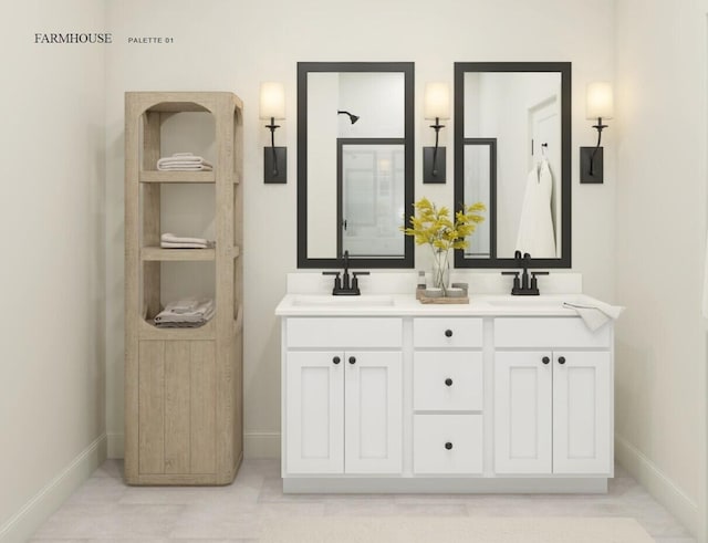 full bathroom featuring double vanity, baseboards, and a sink