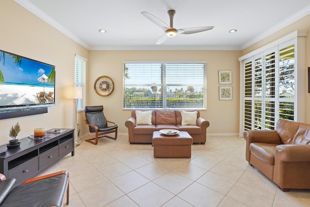 living area with crown molding, light tile patterned floors, a ceiling fan, and baseboards