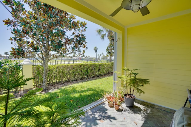 exterior space featuring ceiling fan and fence