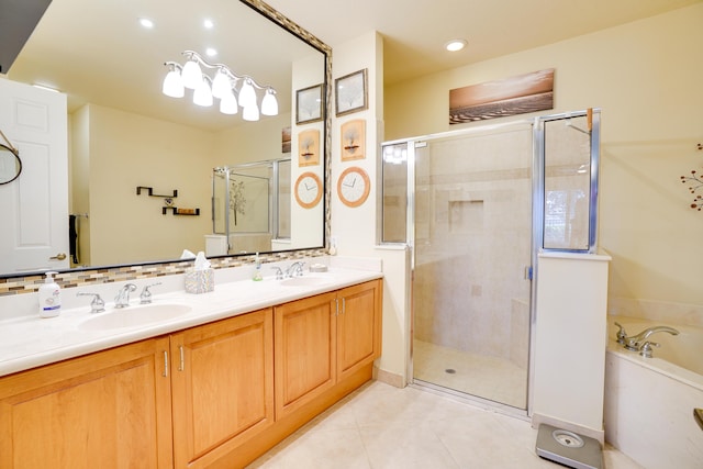 bathroom featuring tile patterned floors, a garden tub, a stall shower, and a sink