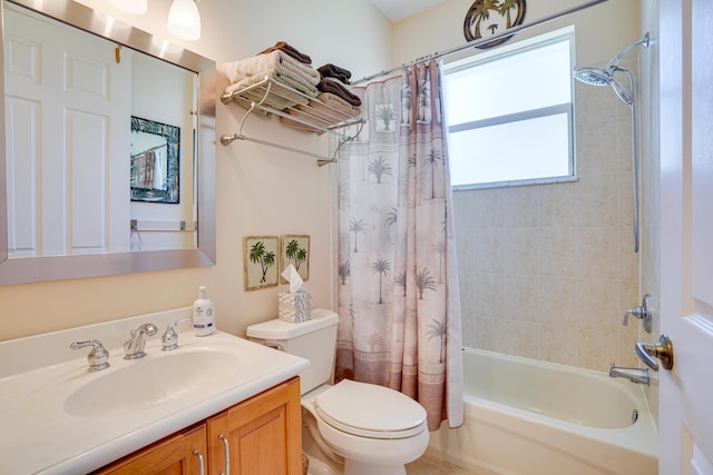 bathroom with shower / bathtub combination with curtain, toilet, and vanity