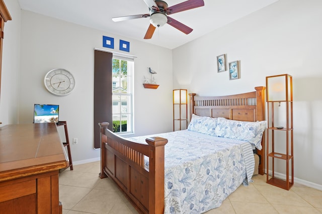 bedroom featuring baseboards, light tile patterned flooring, and a ceiling fan