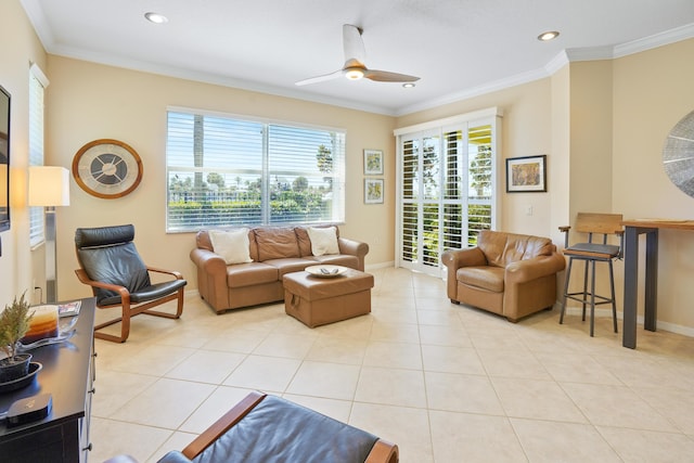 living room with light tile patterned floors, baseboards, ornamental molding, and ceiling fan