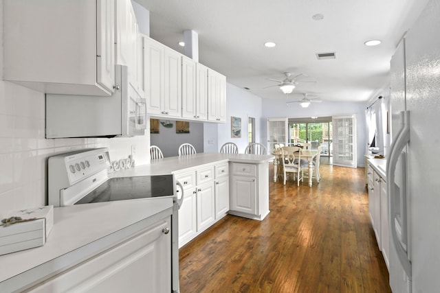2853 White Trout Ln, West Palm Beach, FL 33411 - kitchen with white appliances, a ceiling fan, a peninsula, recessed lighting, and white cabinetry