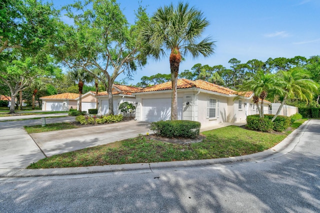 2853 White Trout Ln, West Palm Beach, FL 33411 - mediterranean / spanish home featuring a garage, a tiled roof, stucco siding, and driveway