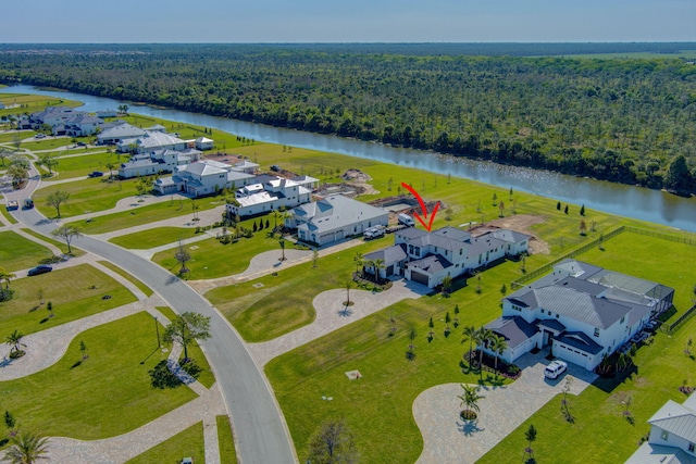 aerial view featuring a residential view, a view of trees, and a water view