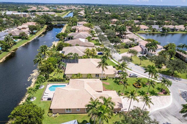 birds eye view of property with a residential view and a water view