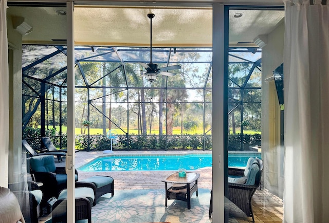 outdoor pool with a lanai and a patio area