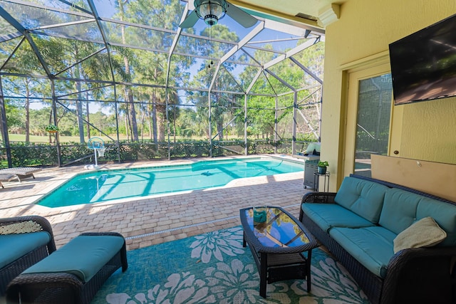 outdoor pool with glass enclosure, a patio, and outdoor lounge area