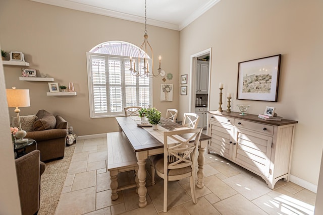 dining space with a notable chandelier, crown molding, and baseboards