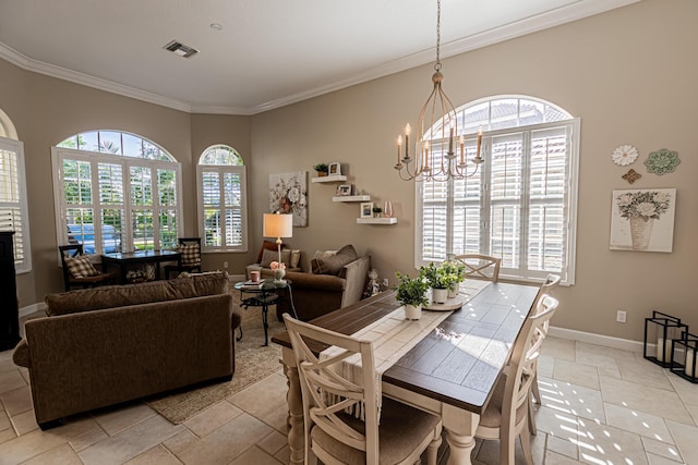 dining space with crown molding, a wealth of natural light, and a chandelier