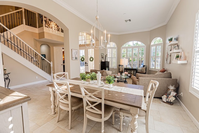 dining space with ornamental molding, visible vents, arched walkways, and baseboards