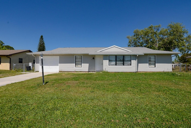 ranch-style home with a front yard, an attached garage, fence, and driveway