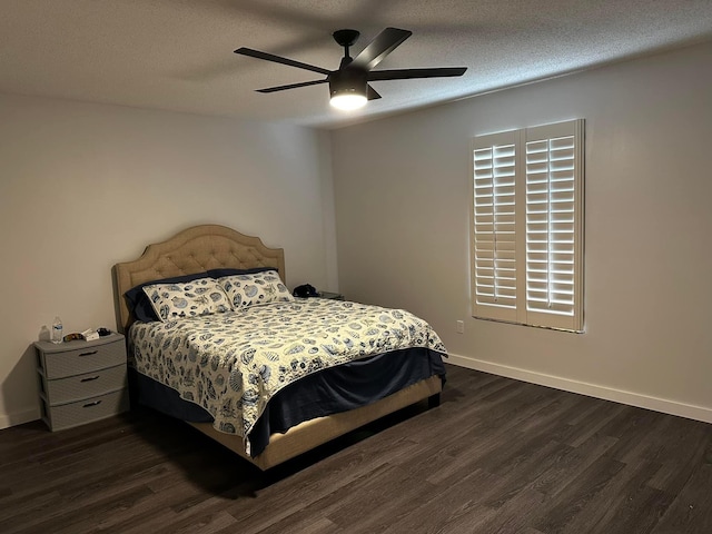 bedroom featuring dark wood finished floors, ceiling fan, a textured ceiling, and baseboards