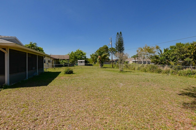 view of yard with a fenced backyard and a sunroom