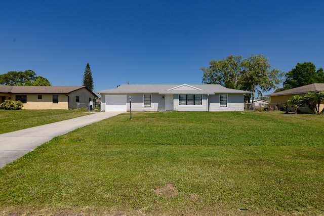 single story home featuring a garage, concrete driveway, and a front yard