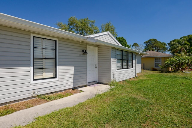 property entrance with a yard