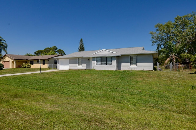 ranch-style house with a front yard, fence, a garage, and driveway